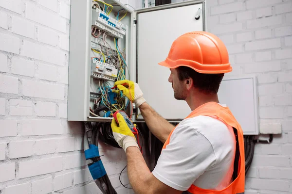 depositphotos_386969798-stock-photo-handsome-electrician-hardhat-gloves-holding